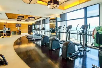 a gym with rows of treadmills in a building at Kaiyana Apartments in Manila