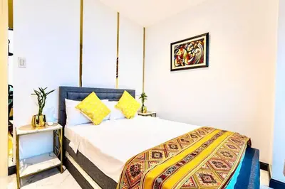a bedroom with a king sized bed in a room at Kaiyana Apartments in Manila