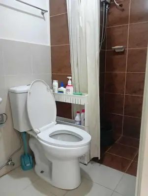 a white toilet in a bathroom with a shower at Ilustrata Residences Condominium in Manila