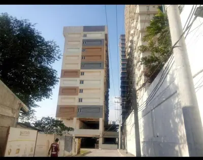 a tall apartment building in the middle of a street at Ilustrata Residences Condominium in Manila
