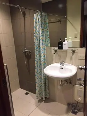 a bathroom with a sink and a shower at Spacious Studio Apartment B302 in Manila