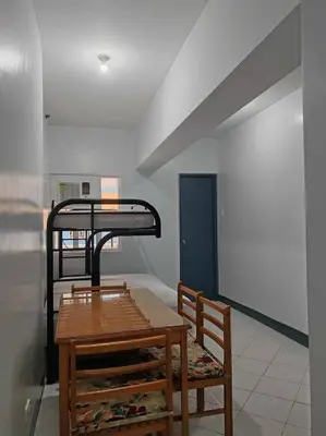 a dining room with a table and a bunk bed at Pacific Regency, Manila studio type with balcony in Manila