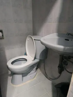 a bathroom with a toilet and a sink at Pacific Regency, Manila studio type with balcony in Manila