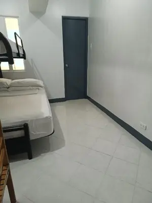 a bedroom with a bed and a tiled floor at Pacific Regency, Manila studio type with balcony in Manila