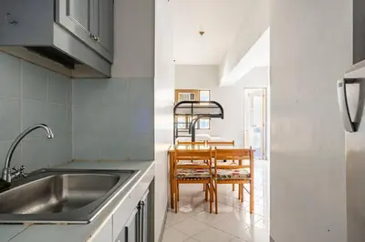 a kitchen with a sink and a table at Pacific Regency, Manila studio type with balcony in Manila