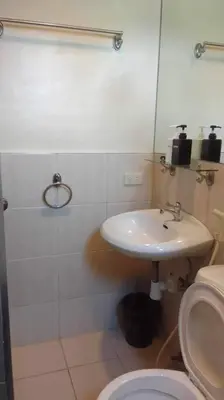 a bathroom with a sink and a toilet at Spacious Studio Apartment B304 in Manila