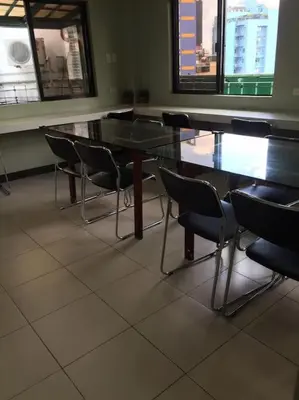 a row of tables and chairs in a room at Spacious Studio Apartment B304 in Manila