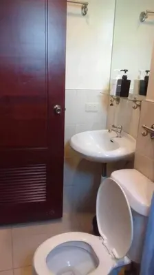 a bathroom with a toilet and a sink at Spacious Studio Apartment B306 in Manila