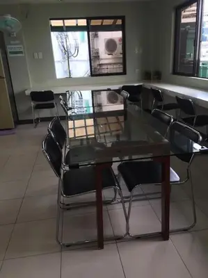 a glass table and chairs in a room at Spacious Studio Apartment B306 in Manila