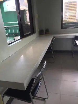 a long counter in a room with two chairs at Spacious Studio Apartment B306 in Manila