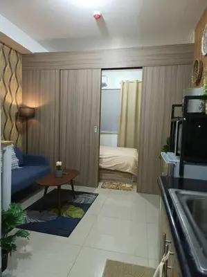 a living room with a couch and a table at CozyCrib in Manila