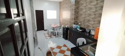a kitchen with a sink and a counter with chairs at 11 Guest - Unit 3 in Santa Rosa