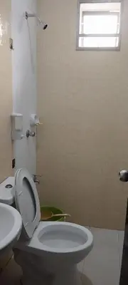 a bathroom with a toilet and a sink and a window at 11 Guest - Unit 3 in Santa Rosa