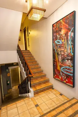 a staircase in a building with a painting on the wall at Z Hostel in Manila