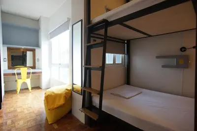 a bunk bed room with two bunk beds and a window at Z Hostel in Manila