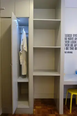 a walk in closet with white shelves at Z Hostel in Manila