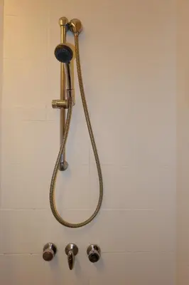 a shower with a shower head in a bathroom at Z Hostel in Manila