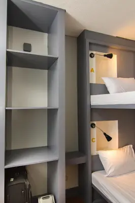 a room with two bunk beds and a closet at Z Hostel in Manila