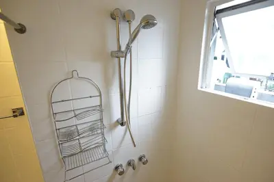 a shower with a shower head in a bathroom at Z Hostel in Manila