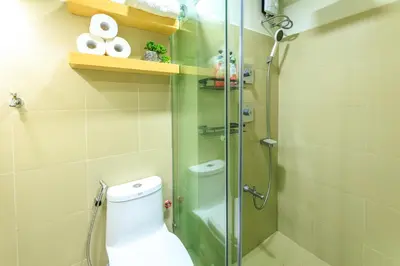 a shower stall with a toilet in a bathroom at Amazing Condo Unit Shore 3 - walking distance to MOA - Pasay - 2 Beds - with 1 extra bed in Manila