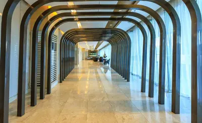 a hallway of an office building with arches at Amazing Condo Unit Shore 3 - walking distance to MOA - Pasay - 2 Beds - with 1 extra bed in Manila