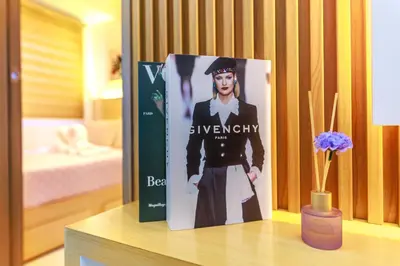 a book on a table with a vase of flowers at Amazing Condo Unit Shore 3 - walking distance to MOA - Pasay - 2 Beds - with 1 extra bed in Manila