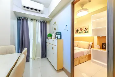 a small bedroom with a bed and a table at Amazing Condo Unit Shore 3 - walking distance to MOA - Pasay - 2 Beds - with 1 extra bed in Manila