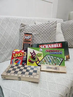 a chess board and other games on a bed at Amazing Condo Unit Shore 3 - walking distance to MOA - Pasay - 2 Beds - with 1 extra bed in Manila