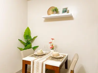 a white dining room with a table and chairs at BGC's Best Condo Near Uptown Mall #oursw15o in Manila