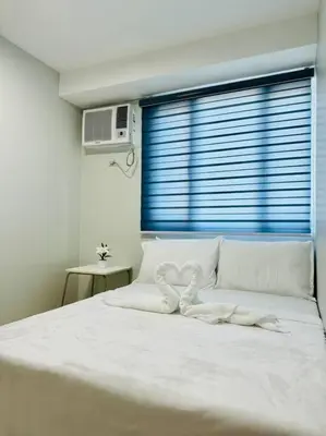 a white bed with two hearts on top of it at Cozy Minimalist 2BR Condo at Princeton QC near Rob Magnolia in Manila