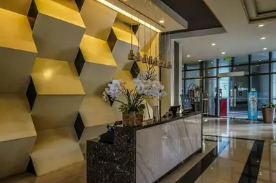 a lobby with a yellow and black wall at New Modern Luxurious 2Bedroom in Eastwood in Manila