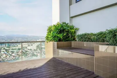 a balcony with plants on the side of a building at New Modern Luxurious 2Bedroom in Eastwood in Manila