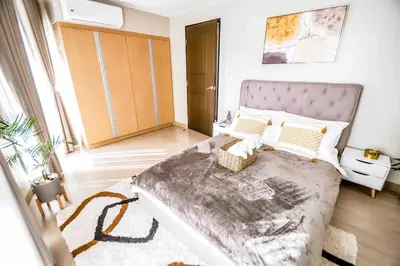a bedroom with a large bed in a room at New Modern Luxurious 2Bedroom in Eastwood in Manila