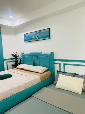 two beds sitting next to each other in a room at Baywatch Tower in Manila