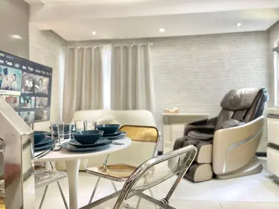 a dining room with a table and chairs at Thompson Suites Fort Victoria Tower BGC Loft Type 1BR in Manila