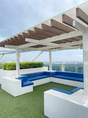 a pavilion with blue seating on a building at The Solaris Point with Pool View in Manila