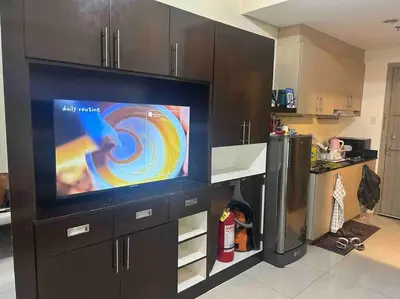 a kitchen with a large flat screen tv in a kitchen at Condo with Bayview in Manila (along Roxas Boulevard) in Manila