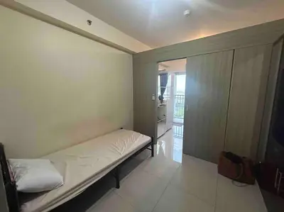 a small room with a bed and a kitchen at Condo with Bayview in Manila (along Roxas Boulevard) in Manila