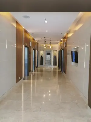 a hallway of a building with a television on a wall at Mall of Asia condotel in Manila