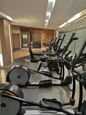 a gym with rows of exercise bikes in a room at Mall of Asia condotel in Manila
