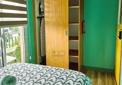 a bedroom with a bed and a book shelf at Cozy 2BR Staycation with Balcony Chateau Elysee for 4-6 Pax in Manila