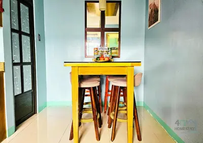 a wooden table with stools in a room at Cozy 2BR Staycation with Balcony Chateau Elysee for 4-6 Pax in Manila