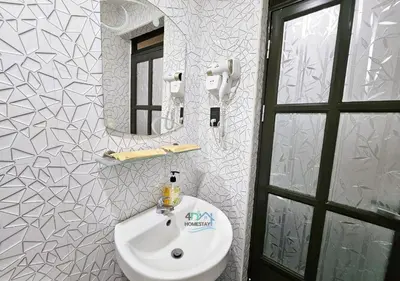 a bathroom with a white sink and a mirror at Cozy 2BR Staycation with Balcony Chateau Elysee for 4-6 Pax in Manila