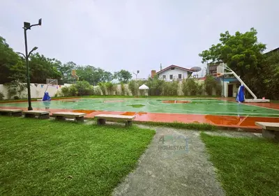 a basketball court with benches in a park at Cozy 2BR Staycation with Balcony Chateau Elysee for 4-6 Pax in Manila