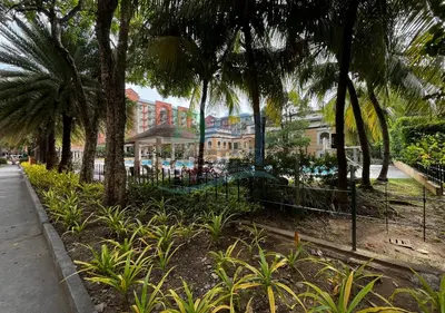 a park with palm trees and a building at Cozy 2BR Staycation with Balcony Chateau Elysee for 4-6 Pax in Manila