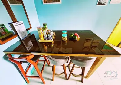 a wooden table with chairs and a bowl of fruit on it at Cozy 2BR Staycation with Balcony Chateau Elysee for 4-6 Pax in Manila