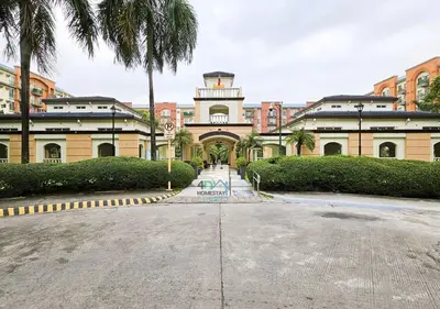 a building with a clock tower on top of it at Cozy 2BR Staycation with Balcony Chateau Elysee for 4-6 Pax in Manila