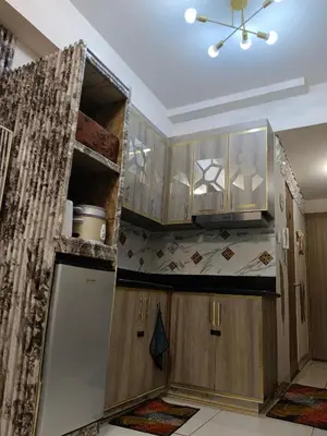 a kitchen with wooden cabinets and a ceiling at Caine's Cabin 27th Feel our Love and Warmth Welcome in Manila