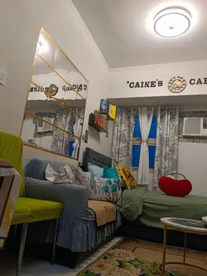 a room with a couch and a bed and a table at Caine's Cabin 27th Feel our Love and Warmth Welcome in Manila