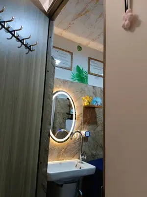 a bathroom with a sink and a mirror at Caine's Cabin 27th Feel our Love and Warmth Welcome in Manila